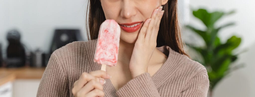 Woman touching her chin feeling sensitive teeth